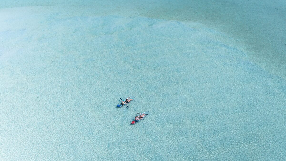 Kayaks floating on crystal clear water