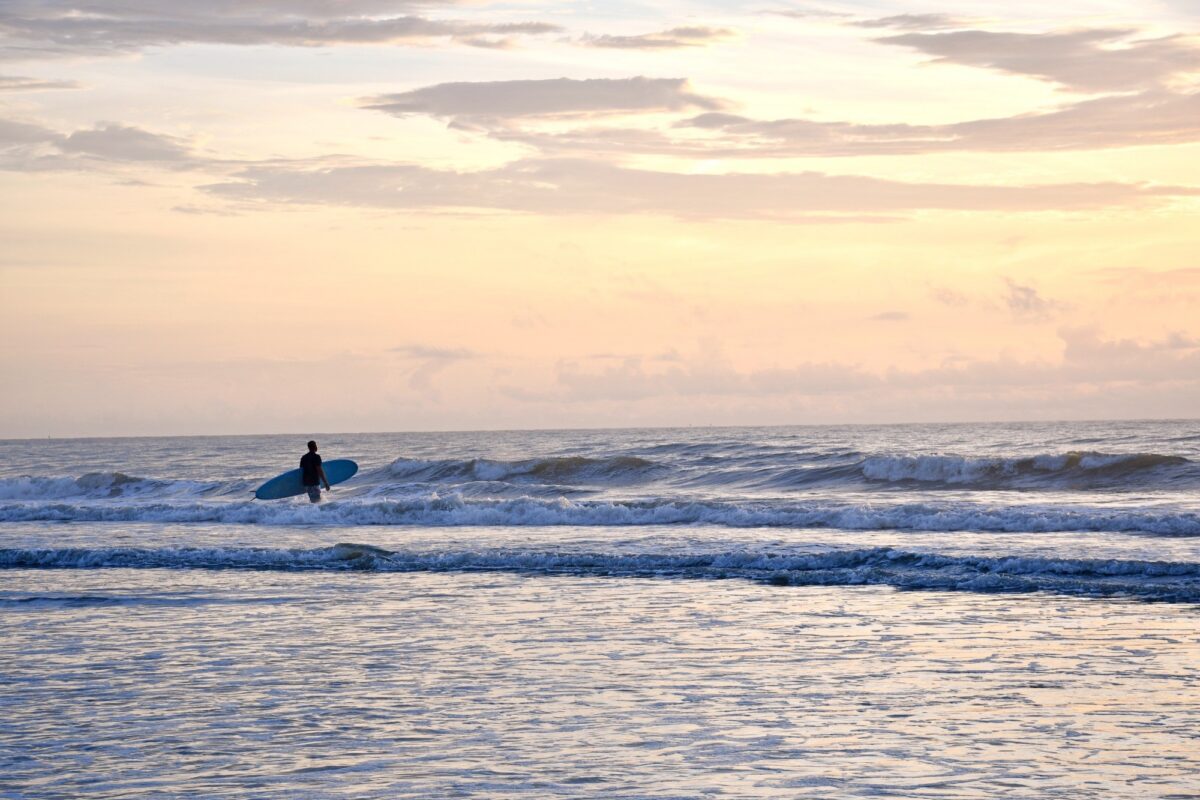 A surfer looks out at the ocean at Cocoa Beach, Florida.
